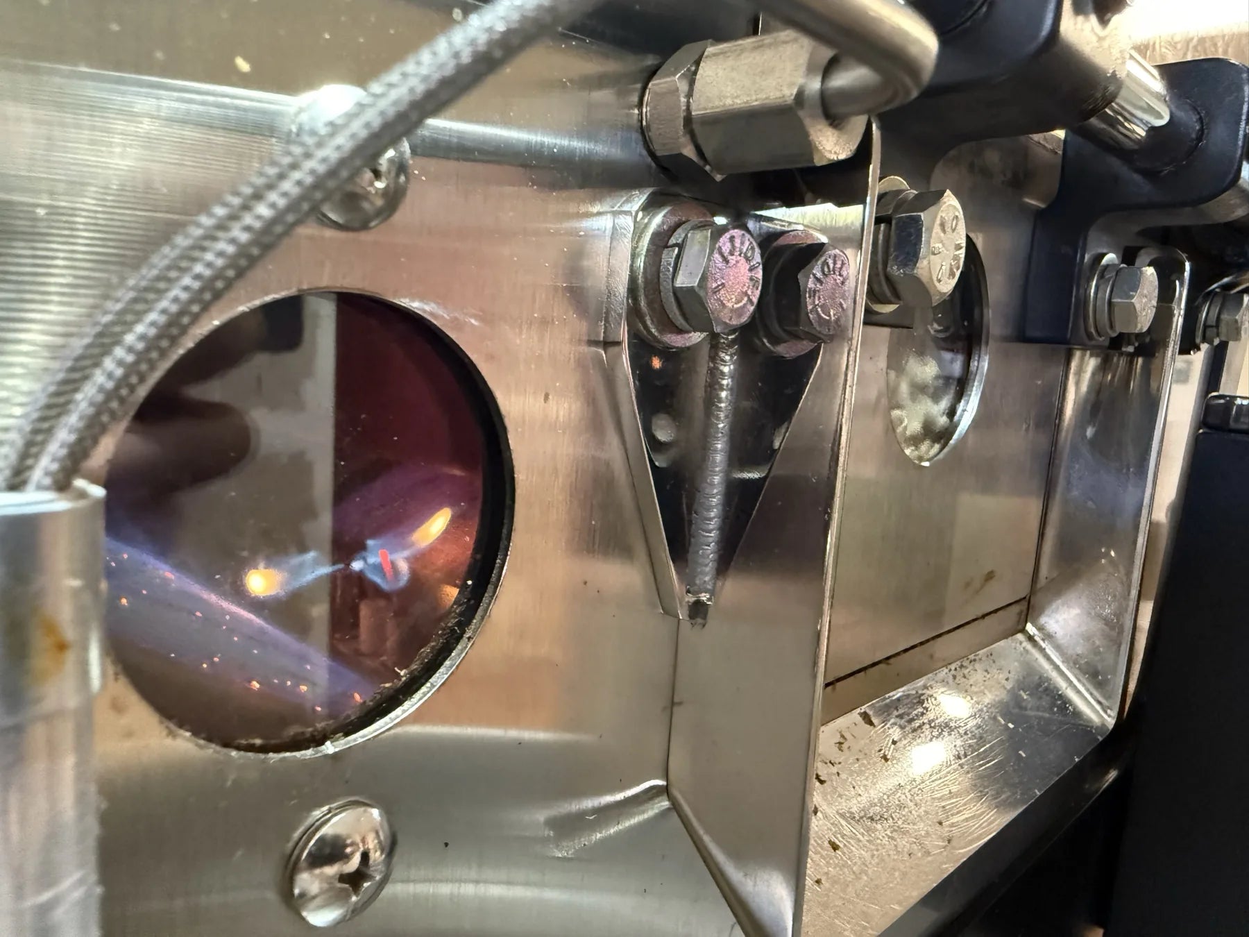 Gas burner flame seen through the roaster sight glass